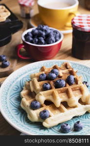 morning and bright breakfast. belgian waffles with blueberries and coffee 