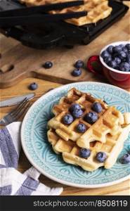 morning and bright breakfast. belgian waffles with blueberries and coffee 