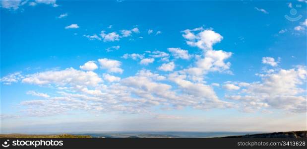 Morning blue sky panorama with cumulus cloud over Crimea mountain plateau. Two shots stitch image.