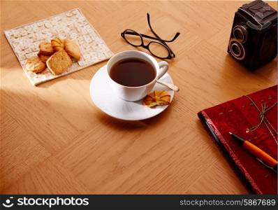 Morning breakfast coffee with vintage red notebook and biscuits
