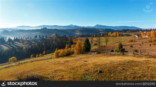 Morning Carpathian mountains and village hamlets on slopes (Yablunytsia village and pass, Ivano-Frankivsk oblast, Ukraine).