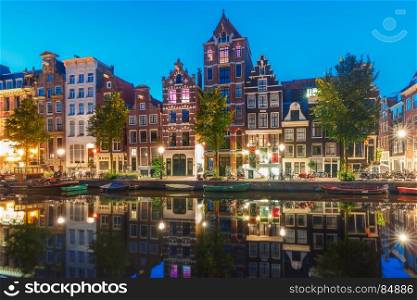 Morning city view of Amsterdam canal Herengracht. Amsterdam canal Herengracht with typical dutch houses and their reflections during morning blue hour, Holland, Netherlands.