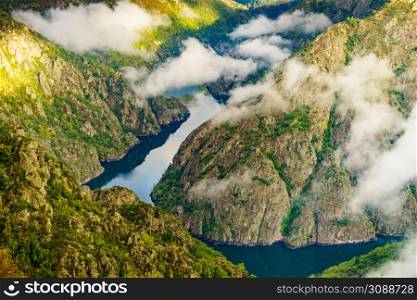 Morning clouds over river Sil Canyon in Parada de Sil in Galicia, Spain. View from Cabezoa lookout. Mountain view. Place to visit.. Mountain view. Clouds over river Sil Canyon, Galicia Spain.