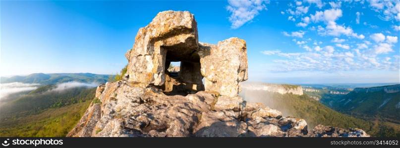 Morning cloudy view from one of Mangup Kale cavernicolous rooms - historic fortress and ancient cave settlement in Crimea (Ukraine). Seven shots stitch image.