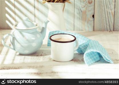 Morning cocoa cup on the kitchen table in shabby chic style. Morning cocoa cup