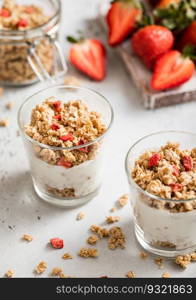Morning dessert strawberry granola with light yogurt in white kitchen.Perfect breakfast