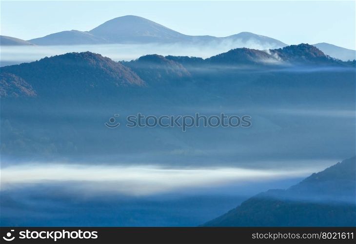 Morning fog over mount tops in autumn Carpathian Mountain.