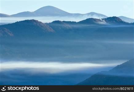 Morning fog over mount tops in autumn Carpathian Mountain.
