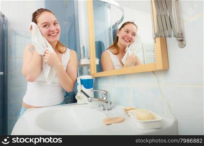 Morning hygiene. Woman cleaning washing her face with clean water in bathroom