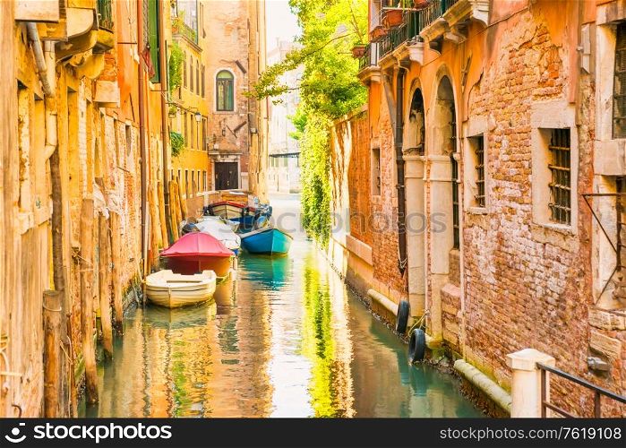Morning in Venice street with canal, boats and gondolas