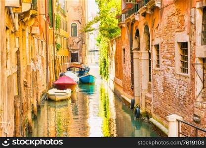 Morning in Venice street with canal, boats and gondolas