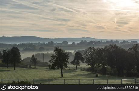 morning landscape with the hills in belgium with mist meadow