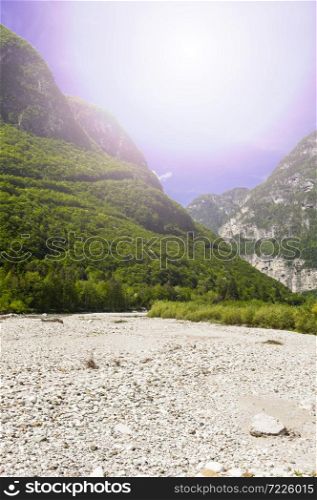 Morning mist in Italian Alps. View of the mountain dry riverbed in Italy at sunrise