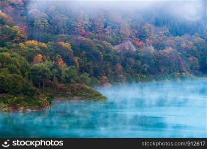 Morning Mist with Autumn Fall Lake and Forest at Tamagawa Dam in Akita Tohoku Japan