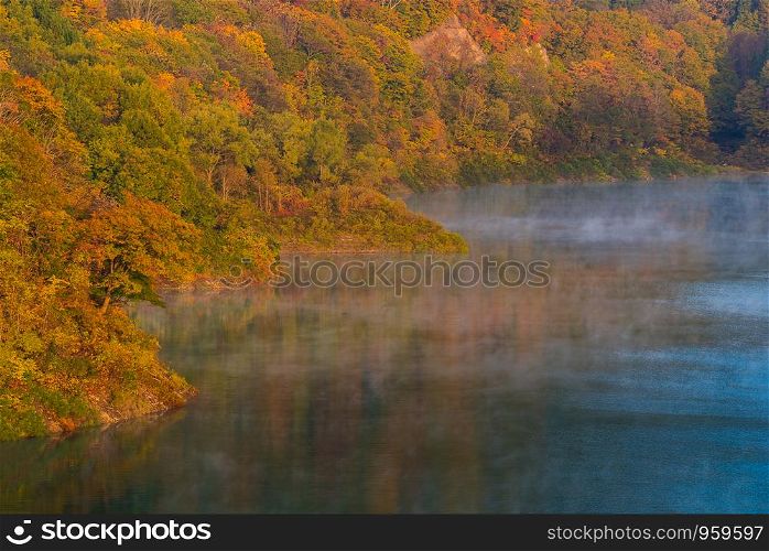 Morning Mist with Autumn Fall Lake and Forest at Tamagawa Dam in Akita Tohoku Japan