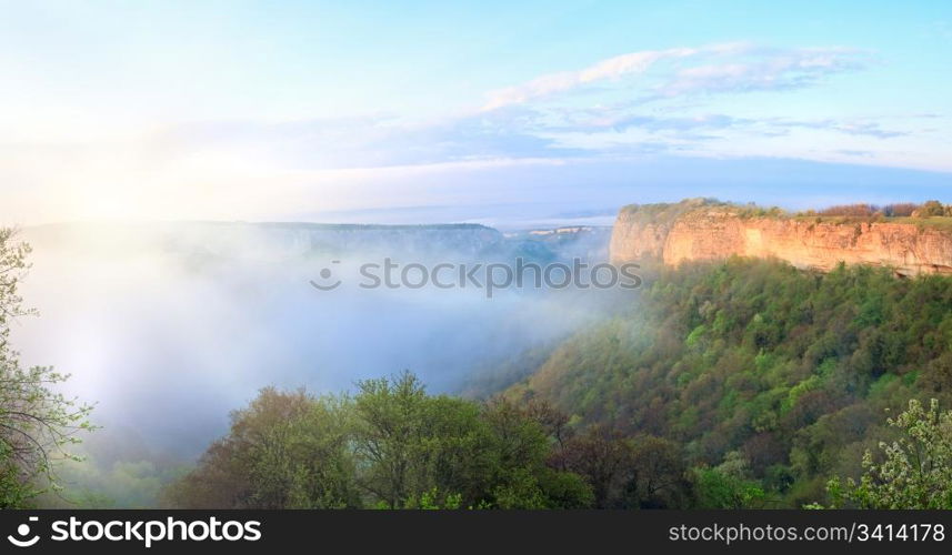 Morning misty view from top of Mangup Kale - historic fortress and ancient cave settlement in Crimea (Ukraine) in sunshine rays. Two shots stitch image.