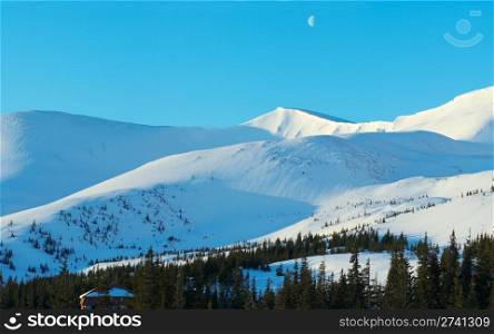 Morning mountain panorama with long blue daybreak shadows and moon in sky (Drahobrat Ski Resort, Yasenja villadge, Zacarpatsjka Region, Carpathian Mt&rsquo;s, Ukraine). Four shots stitch image.