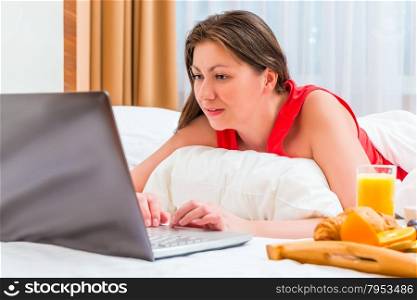 morning of young woman working on a laptop