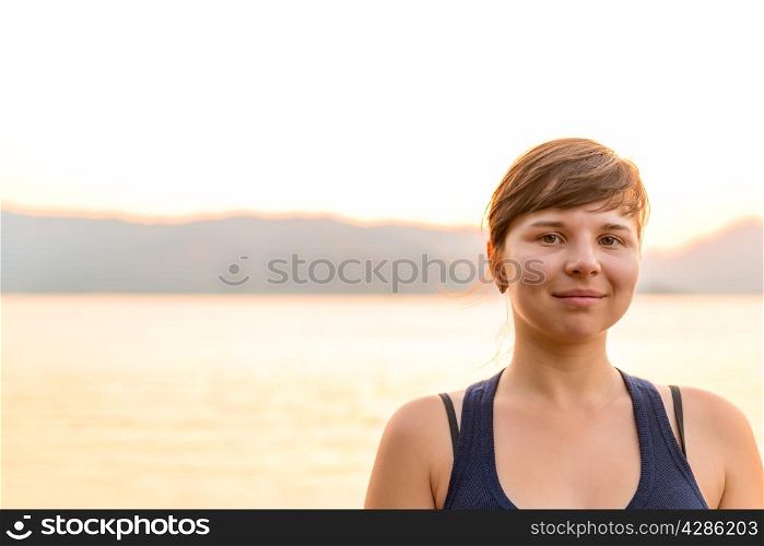 Morning portrait of a woman on a background of sea and mountains