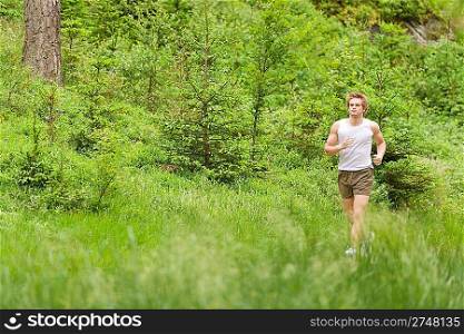 Morning run: Young man jogging in nature in sportive outfit