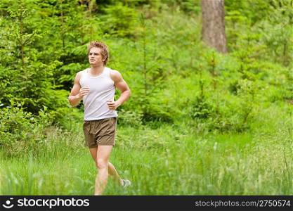 Morning run: Young man jogging in nature in sportive outfit