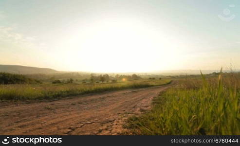 Morning rural landscape at sunrise, wide-angle lens, surface level.