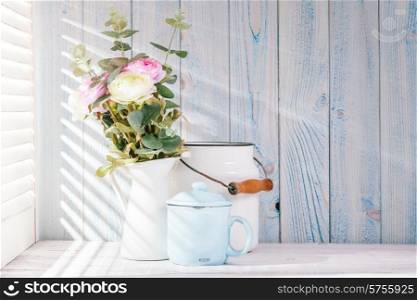 Morning still life on shabby chic table and light from the blinds. Morning still life