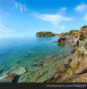 Morning summer Aegean Sea rocky coast landscape with pine trees on shore, Sithonia (near Ag. Kiriaki), Halkidiki, Greece.