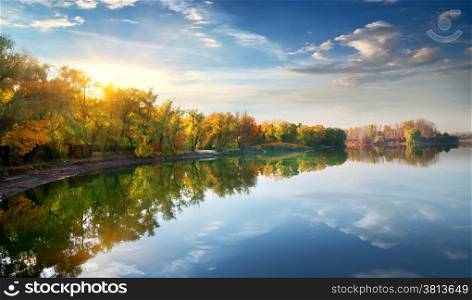 Morning sun over river in the autumn