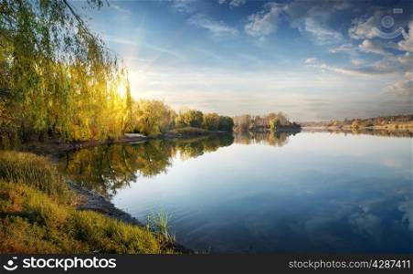 Morning sun over river in the autumn