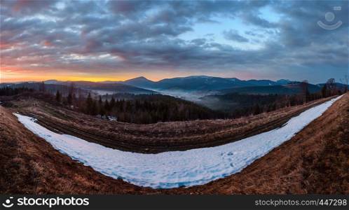 Morning sunrise spring Carpathian mountains plateau landscape with snow-covered ridge tops in far, Ukraine.