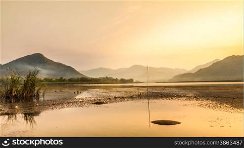 Morning sunshine over reservior and mountain in upcountry at Thailand