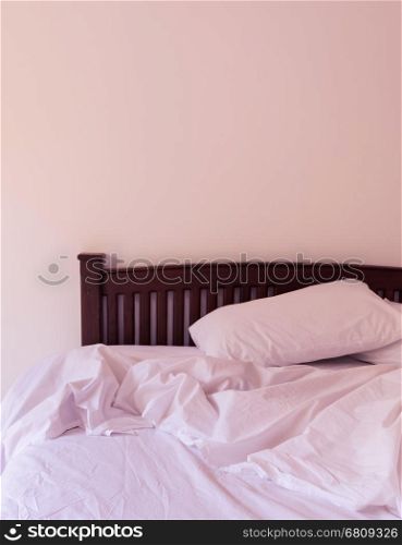 Morning view of an unmade bed in white bedroom. Soft filtered effect image.