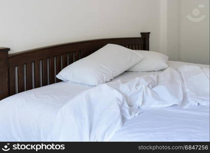 Morning view of an unmade bed . Morning view of an unmade bed in white bedroom