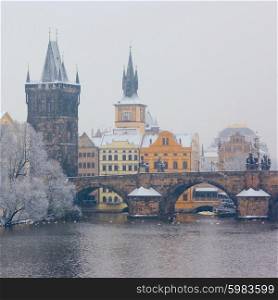 morning view on snow Charles bridge in Prague, Czech Republic