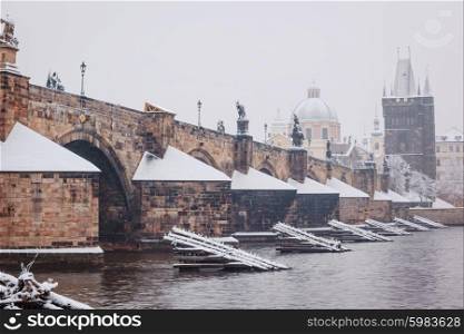 morning view on snow Charles bridge in Prague, Czech Republic