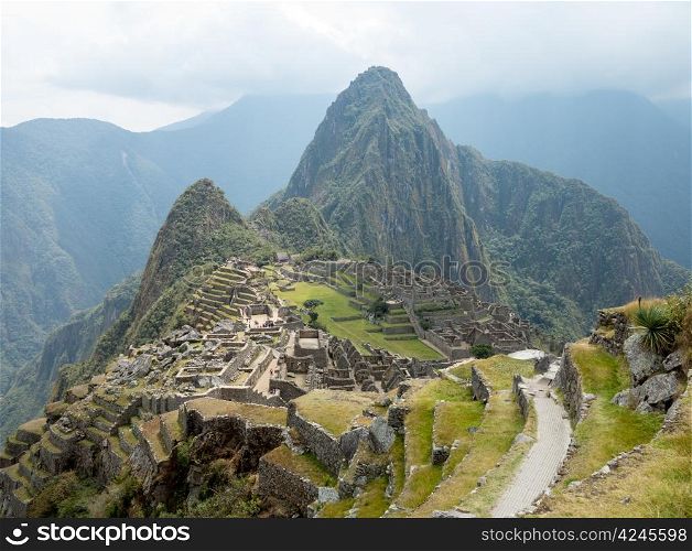 Morning views of Machu Picchu as mist clears from the mountainside