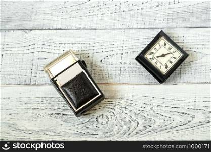morning. vintage electric shaver and retro alarm clock on shabby white wooden background