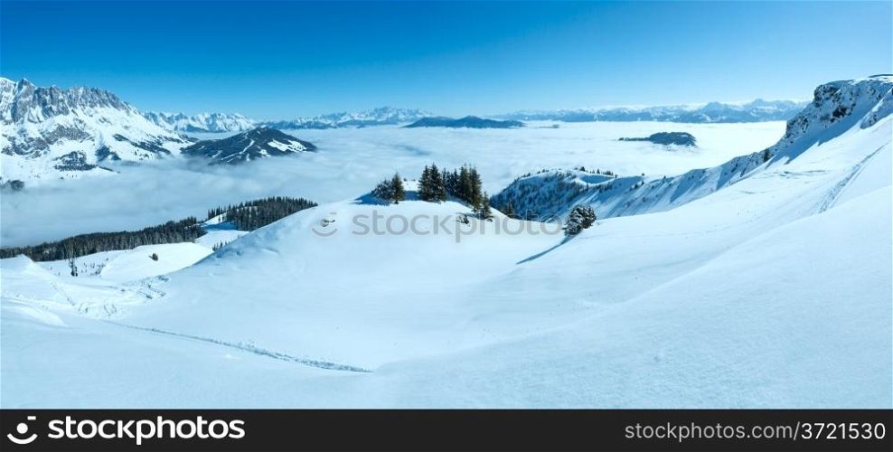 Morning winter mountain landscape with clouds in below valley (Hochkoenig region, Austria). All people are not recognizable.