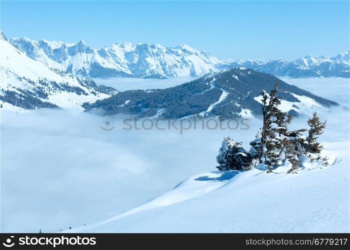 Morning winter mountain landscape with clouds in below valley (Hochkoenig region, Austria)