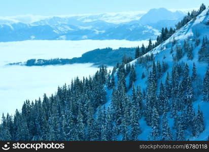 Morning winter mountain landscape with clouds in below valley (Hochkoenig region, Austria)