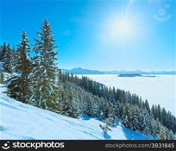 Morning winter mountain landscape with clouds in below valley (Hochkoenig region, Austria) and sunshine