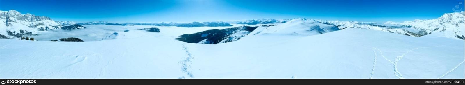 Morning winter mountain panorama with clouds in below valley (Hochkoenig region, Austria)