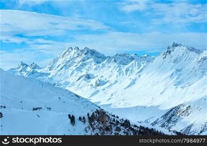 Morning winter Silvretta Alps landscape with ski run and ski lift (Tyrol, Austria). All skiers are unrecognizable.