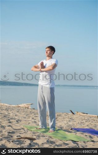 Morning Yoga Meditation at the Beach by man