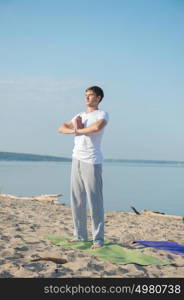 Morning Yoga Meditation at the Beach by man