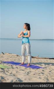 Morning Yoga Meditation at the Beach by woman