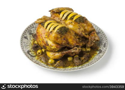 Moroccan chicken dish with chermoula, olives and preserved lemon on white background