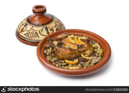 Moroccan dish with chicken and lemon on white background
