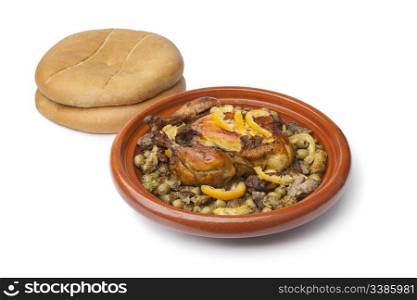 Moroccan dish with chicken and lemon on white background